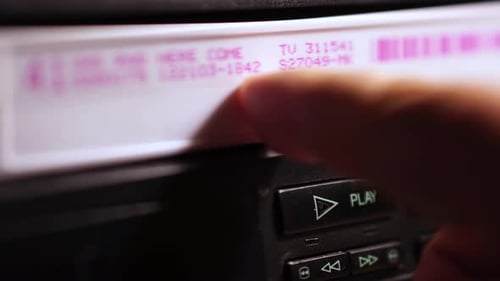 VHS Video Cassette and VCR, Inserting Tape in Player, Close Up