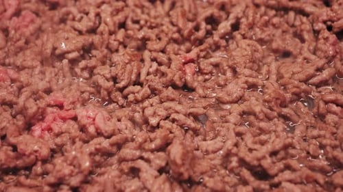 A Closeup of Fresh Ground Beef The Cook Begins Preparing Pasta Bolognese and Fries the Ground Beef