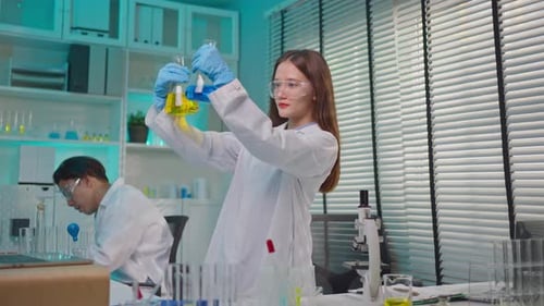 Asian female scientist working in biotechnology research laboratory.