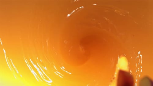Super Slow Motion Shot of Fresh Peaches Falling Into Juice Whirl