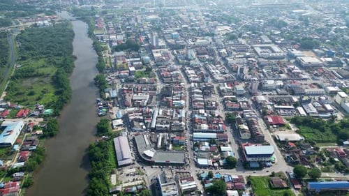 A city with a river running through it. Aerial Batu Pahat in sunshine morning
