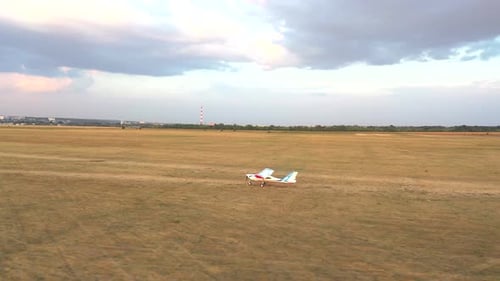 Small Airplane Riding Along Rural Runway Before the Takeoff
