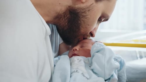 Father His Cute Newborn Baby Boy in Hospital Room Handsome Dad Carrying His