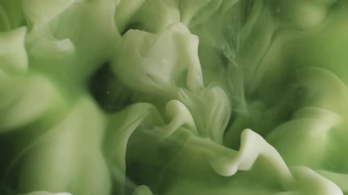 Abstract White Ink Mixing With Green Liquid