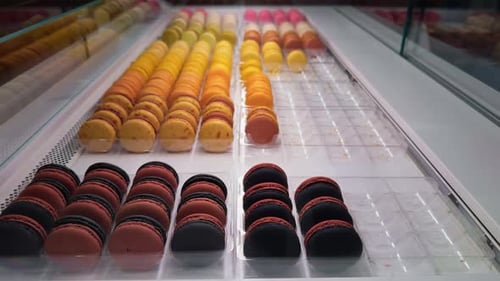 A Stunning and Colorful Arrangement of Macarons in a Charming Pastry Shop Can Entice Numerous