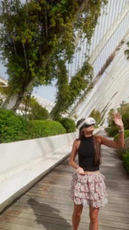 Woman Using VR Headset in a Futuristic Park