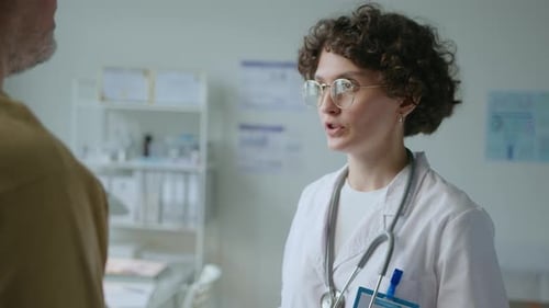 Attentive Female Doctor Supporting Patient during Treatment in Clinic