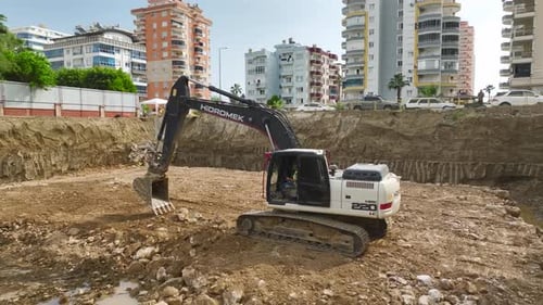 Building the Future Aerial of Soil Unloading Into Foundation