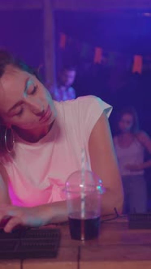A Thoughtful Woman in a Vibrant and Colorful Nightlife Scene Filled with Life and Energy