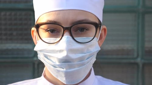 Medical Professional Wearing Mask and Glasses Close Up