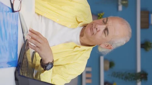 Vertical video of Home office worker old man freelancing.