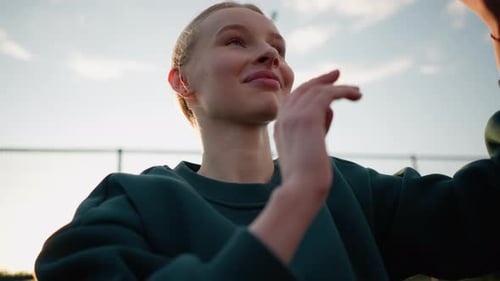 Closeup of Lady in Green Sweater Playing Volleyball with Sunlight Glow