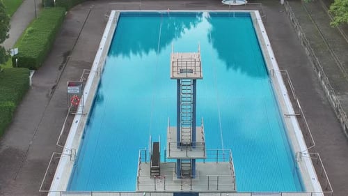 Aerial view of a tranquil swimming pool surrounded by greenery, Germany.