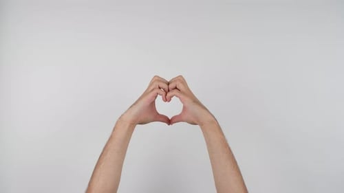 Hands Forming Heart Shape on White Background