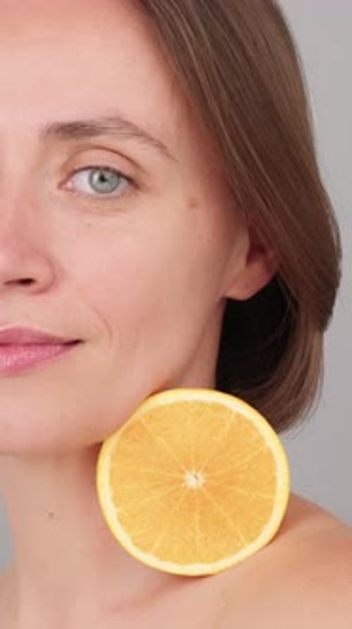 Attractive Woman Posing with an Orange Slice