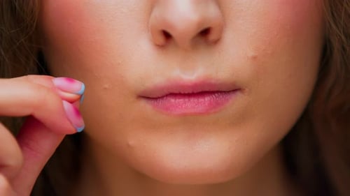 Portrait of Young Woman Face with Close Mouth and Shut Up Hand Gesture on Camera
