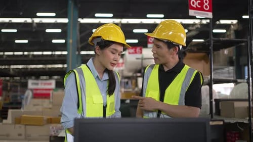 Blue collar workers are working at warehouse.