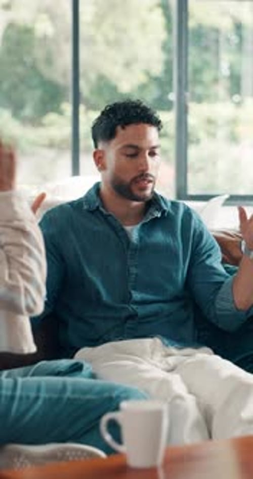 Indoor Conversation Between Man and Woman on Couch