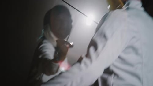 Swordswoman in Epee Mask Fighting with Foil Sword During Duel