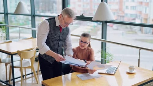 Business Professionals Discuss Charts in Office Workplace