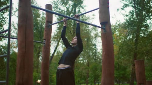 Man Pulls Up on Bar in Outdoor Gym