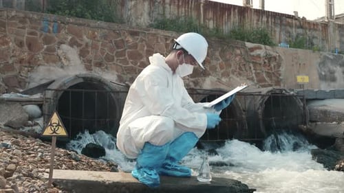 Ecologist Sampling Water of Toxic Chemicals From the River Checking List and Write to Clipboard