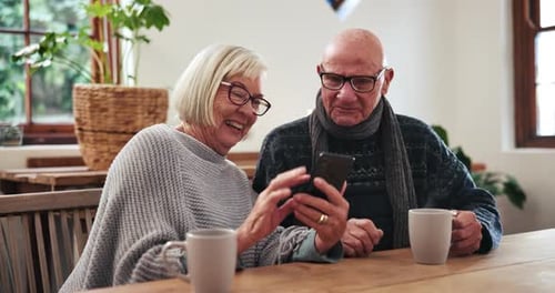 Senior Couple Sharing Smartphone at Home