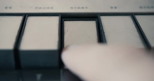 Pressing Start Button On A Vintage Tape Recorder