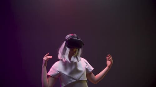 Girl immersed in abstract neon vr world dances alone augmented reality slow motion