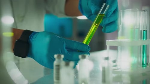 Liquid. A doctor of microbiology in a protective suit works efficiently on samples in his office