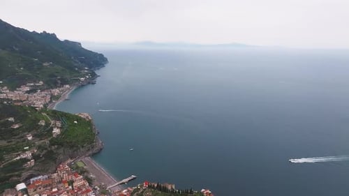 Aerial View of Amalfi Coastline with Motorboat and Coastal Town