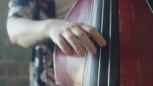 Young Musician Plays Double Bass, Close Up