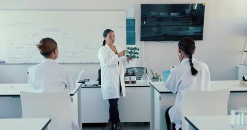 Enthusiastic Teacher Explains a Science Model in Class