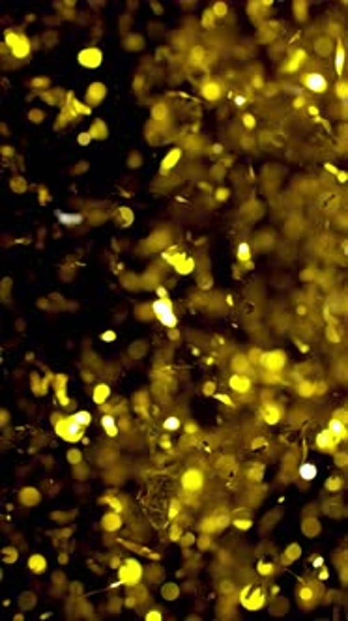 Golden Glitter and Confetti Falling on Black