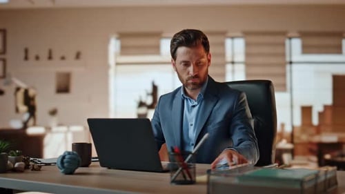 Professional Man Working on Laptop, Takes Phone Call