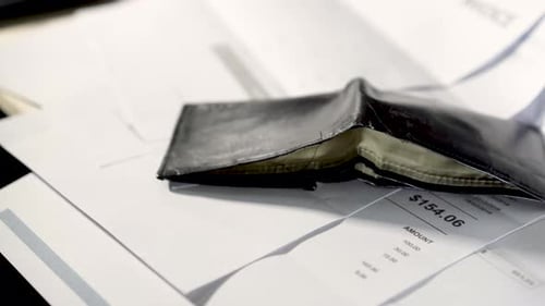 Dolly shot over unpaid bills stock video.The wallet that has no money on the invoice