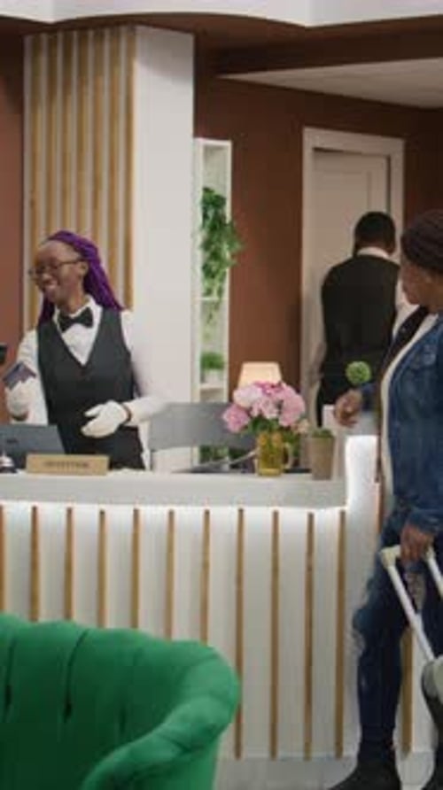 Hotel Receptionist Serving Customer in Hotel Lobby