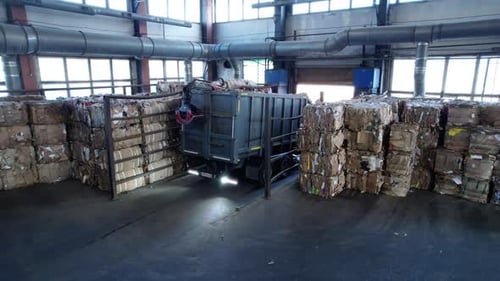 Truck Reverses Into Warehouse with Waste Paper Bales