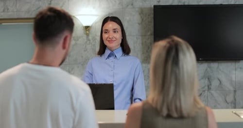 Administrator Giving Tourist Man Key Card at Hotel Desk Concierge Service Woman Smile in Lobby for