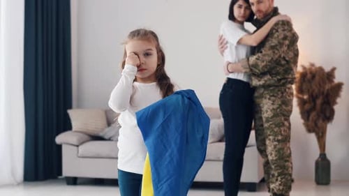 Sad Girl with Ukrainian Flag, Family Hugs Soldier