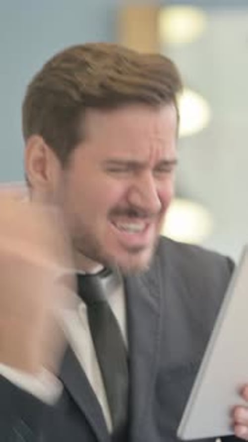 Annoyed Businessman Using Tablet in Vertical Video