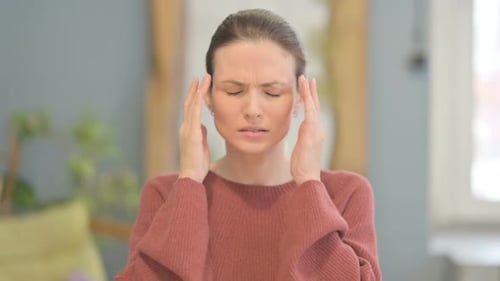 Woman Massaging Temples Experiencing Headache