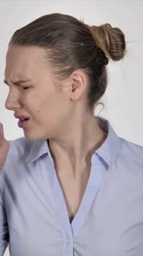 Sick Woman Coughing, Holding Chest in Discomfort