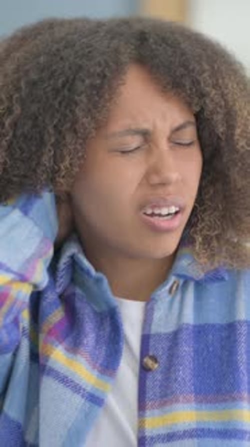Young Woman Massaging Sore Neck in Vertical Video