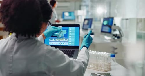 Scientist Working in Modern Laboratory with Pipette