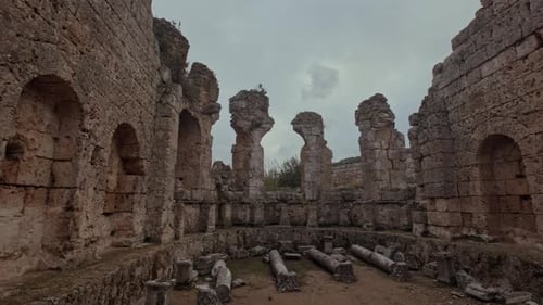 Ancient stone structure with fallen columns