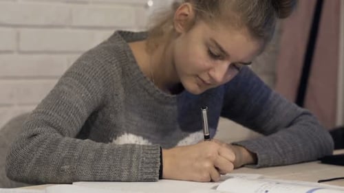 Focused Teenager Studying at Desk