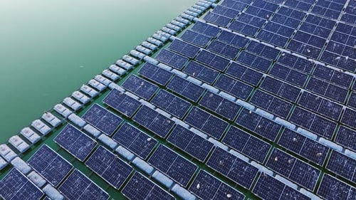 Aerial View of Floating Solar Power Grid on Water With Birds and Clean Light