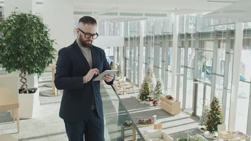 Businessman Using Digital Tablet in Office