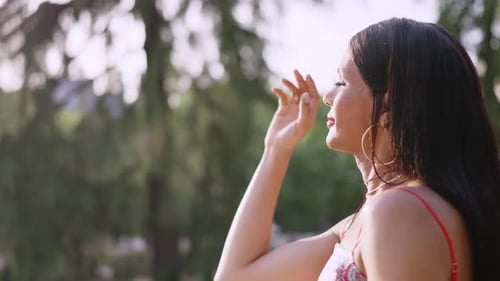 Stylish Woman Enjoys Sunlight in Urban Park